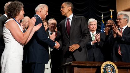 El expresidente Barack Obama estrecha la mano del actual presidente de EE UU Joe Biden, en julio de 2010, después de firmar la Ley Dodd-Frank de reforma de Wall Street y de protección del consumidor.