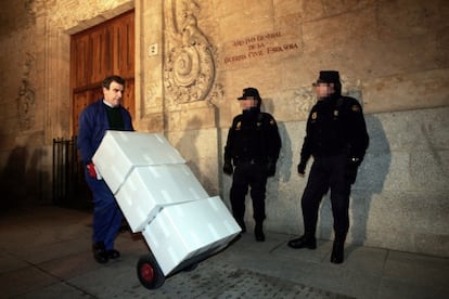 An officer moves boxes containing the so called Salamanca Papers on January 19, 2006 under the watchful eye of police.