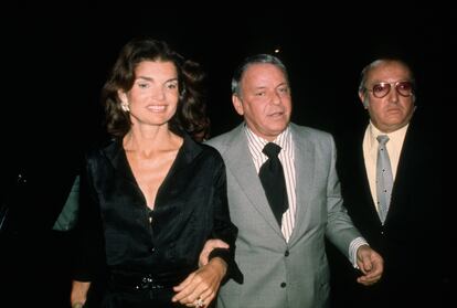 Jacqueline Kennedy Onassis, Frank Sinatra y el guardaespaldas Jilly Rizzo llegando al Club 21 en 1975 tras un concierto del cantante en Nueva York. 