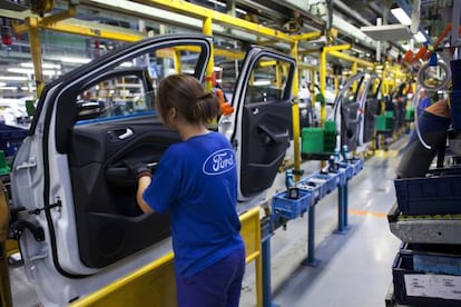 Workers at an auto assembly plant.