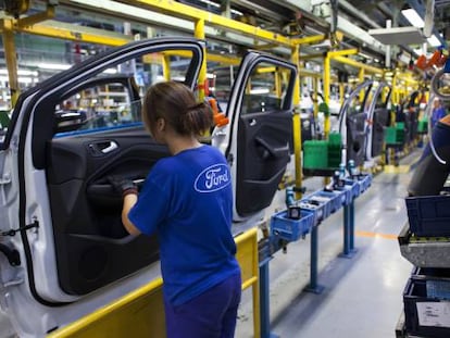 Workers at an auto assembly plant.