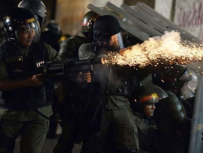 National Guard troops fire tear gas at demonstrators in Caracas.