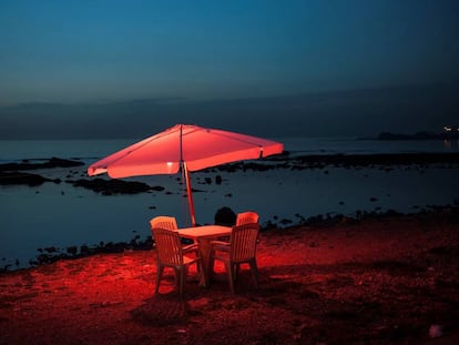 Una mesa y unas sillas de plástico junto al mar, en Trípoli, Líbano.