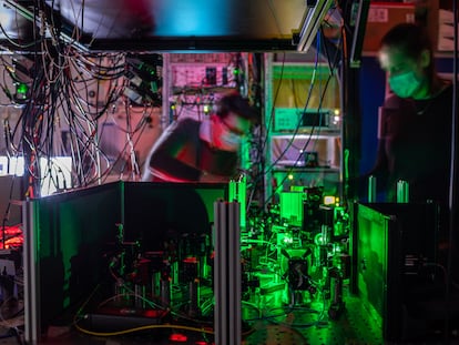 Investigadores de QuTech trabajan en uno de los nodos de la red cuántica, donde los espejos y filtros guían los rayos láser hacia el chip de diamante.