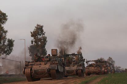 Israeli soldiers ride in armoured personnel carriers (APCs), amid the conflict between Israel and the Palestinian Islamist group Hamas, near the Israel-Gaza border, in Southern Israel, December 25, 2023.