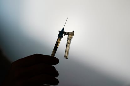 A syringe is prepared at a clinic in Norristown, Pa., Dec. 7, 2021