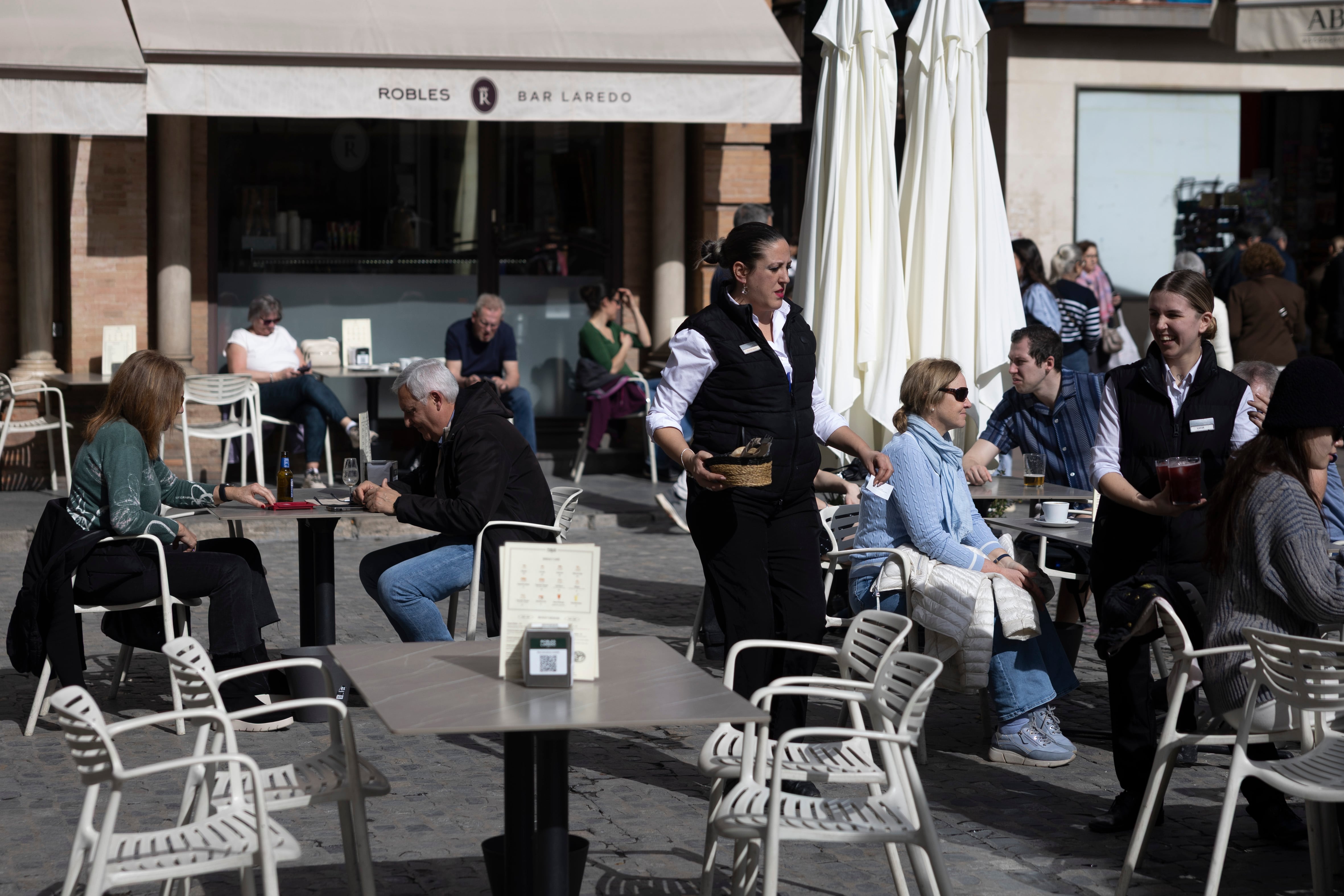 Dos camareras atienden una terraza en Sevilla, el 12 de febrero de 2026