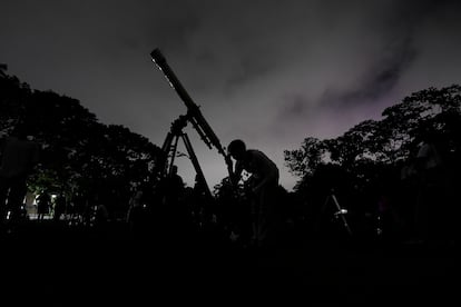 A girl looks at the moon through a telescope in Caracas, Venezuela, on Sunday, May 15, 2022.