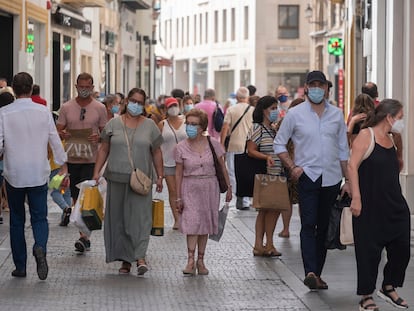 Varias personas con mascarilla por las calles comerciales del centro de Sevilla.