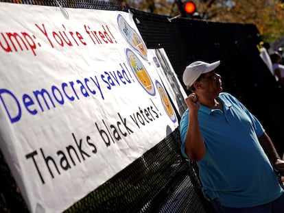 Jerry Nickens, a DC native, stands in front of a sign thanking Black voters outside of St. John's Church near the White House, U.S., November 8, 2020.