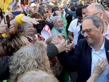 El presidente de la Generalitat, Quim Torra, (derecha), saluda a asistentes de la manifestaci&oacute;n este s&aacute;bado en Madrid. 