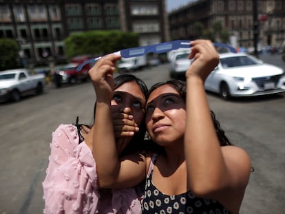 Young people observe the solar eclipse in Mexico City.