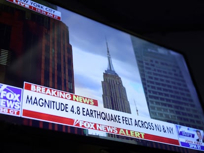 Una pantalla de televisión en el edificio de la Bolsa de Nueva York informa del terremoto de este viernes.