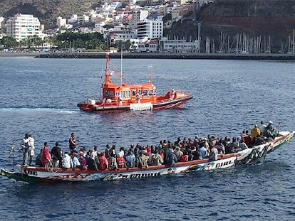 Una gran piragua con 103 ocupantes llega al puerto de San Sebastián de la Gomera escoltada por un barco de Salvamento Marítimo.