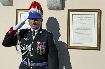 Un guardia del palacio de Mónaco, ante el cartel que anuncia el nacimiento de los mellizos.