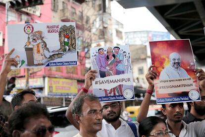 Activists raise placards and shout slogans against Prime Minister Narendra Modi during a protest march over sexual violence against women in the northeastern state of Manipur, on July 28, 2023.