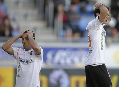 Edu, (a la izquierda), y Mata se lamentan por el desastroso partido del Valencia ante el Numancia, que le derrotó.