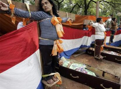 Un grupo de mujeres crucificadas participaron en una protesta en la céntrica Plaza Uruguaya de Asunción (Paraguay). Las mujeres pertenecen al colectivo de los sin techo, y en la protesta hubo representaciones alegóricas con ataúdes contra la Secretaría de Acción Social, que excluyó a los representantes de esas organizaciones en los programas de viviendas populares.