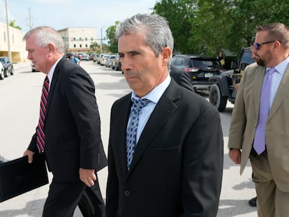Carlos De Oliveira, center, property manager of former President Donald Trump's Mar-a-Lago estate, leaves the Alto Lee Adams Sr. U.S. Courthouse following his arraignment hearing, Tuesday, Aug. 15, 2023, in Fort Pierce, Fla.