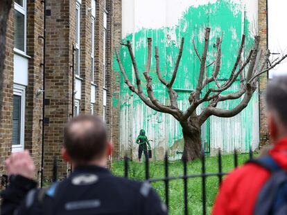 People view a new mural attributed to the British artist Banksy on a wall in north London, Britain, March 18, 2024.