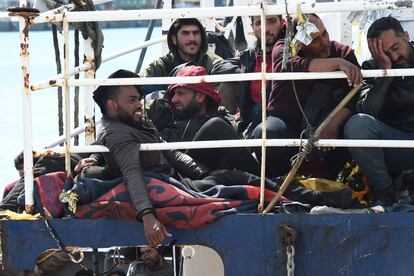 Migrants wait to disembark at the Sicilian port of Catania.