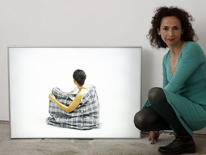 La pintora y fotógrafa colombiana Luz Ángela Lizarazo, junto a una obra de la colección <i>El Dorado</i>.