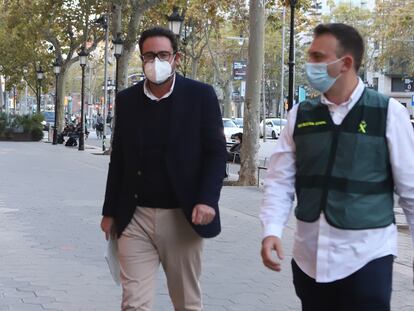 David Madí, acompañado de un Guardia Civil  llegando a su despacho del paseo de Gràcia de Barcelona. Foto: CRISTÓBAL CASTRO