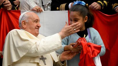 Pope Francis blesses a child during a weekly general audience, at the Vatican, December 13, 2023.