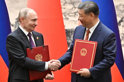 El presidente de Rusia, Vladímir Putin saluda a su homólogo chino, Xi Jinping, este jueves en Pekín.  