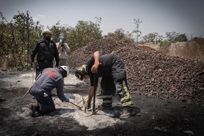 Buscadores y bomberos en el terreno donde se encontró el supuesto crematorio, este 1 de mayo.