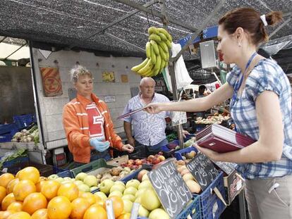 Daniela Varzari reparte folletos sobre los comicios europeos en un mercado de Coslada.