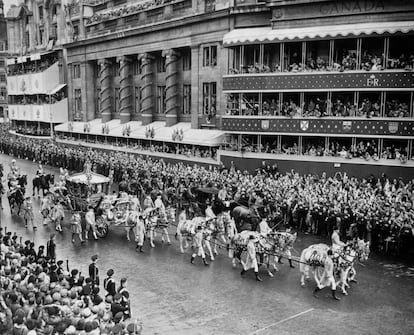 The Coronation procession on the return from Westminster Abbey to Buckingham Palace. The State Coach passes Sir Winston Churchill's coach, which had to fall out altogether and was held up outside Canada House.   