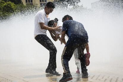 Varios jóvenes tratan de paliar en una fuente las altas temperaturas de este martes en la capital de México.