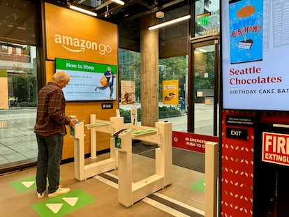 An Amazon Go customer pays with the store's mobile app at the self-service checkout counter.