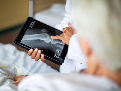 Cropped shot of a female doctor showing result of radiography on digital tablet to patient and giving diagnosis