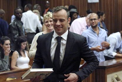 Oscar Pistorius reacts after he was granted bail as he leaves the North Gauteng High Court in Pretoria, South Africa after his bail hearing December 8, 2015.