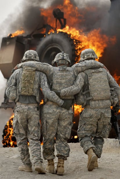 Dos soldados estadounidenses ayudan a un compañero herido en julio en Afganistán.