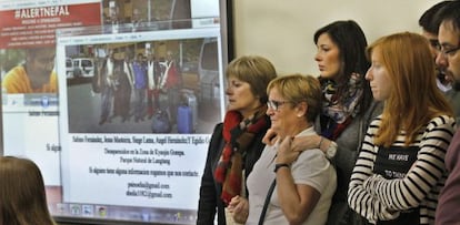 Family members of a mountain-climbing team from Asturias gather in front of a photograph of their missing loved ones.