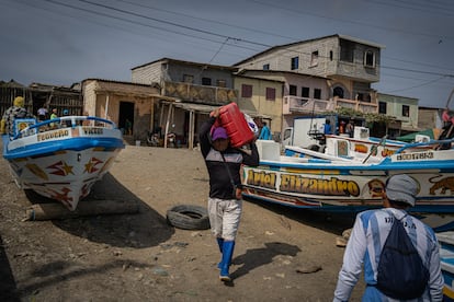 Agapito carga un bidón de gasolina para salir a faenar. Desde que conoció a su mujer hace años, ya no se viste con ropa tradicionalmente femenina. A la mayoría de niños en Engabao los padres les enseñan desde pequeños el oficio de la pesca del camarón, una de las pocas salidas profesionales que hay en la zona, un trabajo duro en condiciones de calor extremo y durante largas jornadas.