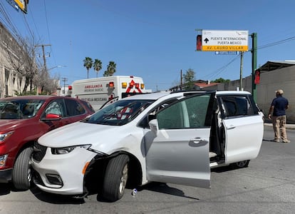 A member of the Mexican security forces stands next to a white minivan with North Carolina plates and several bullet holes, at the crime scene where gunmen kidnapped four US citizens.