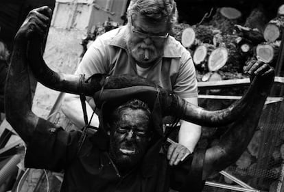 A Luzón resident adjusts the horns of one of the devils during the celebrations.