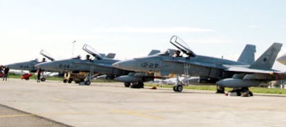 Members of Spain's air force next to an F18 at an Italian base.