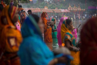 Mujeres hindúes participan en una ceremonia de oración celebrada al atardecer en el río Singhiya con motivo del festival Chhath, en Biratnagar (Nepal).