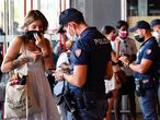 Police officers check travellers outside Porta Garibaldi station Milan, Italy, September 1, 2021. REUTERS/Flavio Lo Scalzo