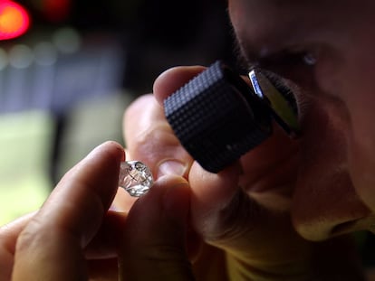 An employee looks at a rough diamond at Flanders Manufacturing, as the G7 weighs a ban on Russian diamond imports, Antwerp, Belgium, October 30, 2023.