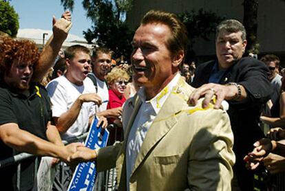 Arnold Schwarzenegger recibe el golpe de un huevo durante una visita ayer a la Universidad de California.