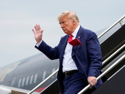 El ex presidente de EE UU, Donald Trump, saluda mientras baja del avión para comparecer ante el tribunal federal de Washington.