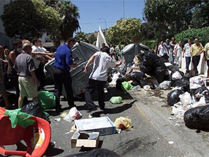 Vecinos de Torre del Mar desparraman las basuras acumuladas por la huelga en las calles del núcleo turístico.