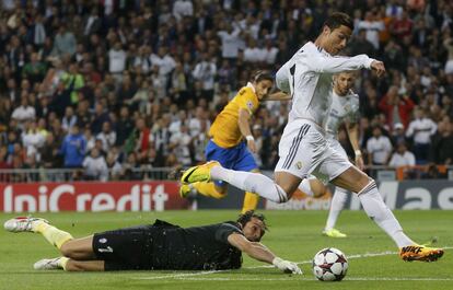 Cristiano Ronaldo regatea al portero de la Juventus Gianluigi Buffon para marcar un gol durante el partido de fútbol de la Liga de Campeones en el estadio Santiago Bernabéu de Madrid 23 de octubre 2013