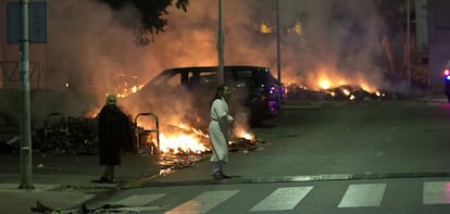 Vecinos de Jerez queman basuras y se enfrentan a la polic&iacute;a por segunda noche. Dos vecinas en medio de varios coches incendiados y varios contenedores.